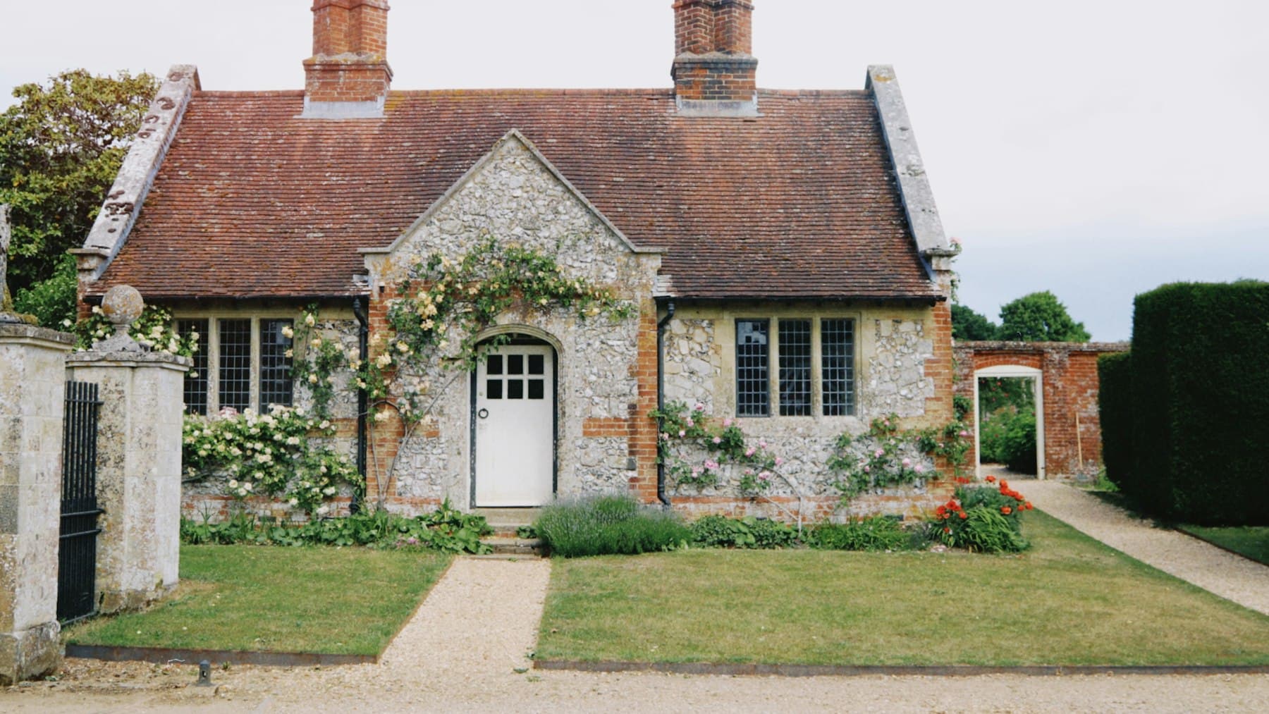A well-kept stone cottage with a tidy front path and planting, used to show a sale-ready first impression.