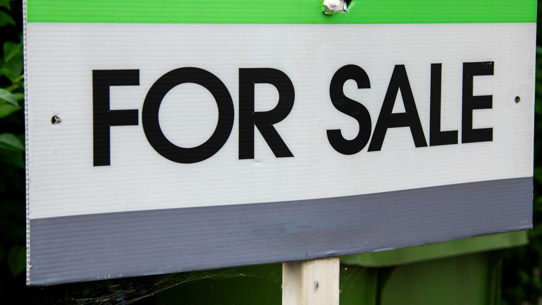 A close-up of a for sale sign, representing a property listing that needs a stronger relaunch.